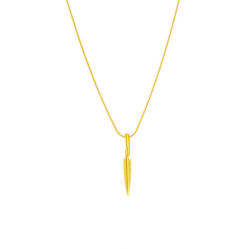 Gold necklace with a feather pendant on a white background