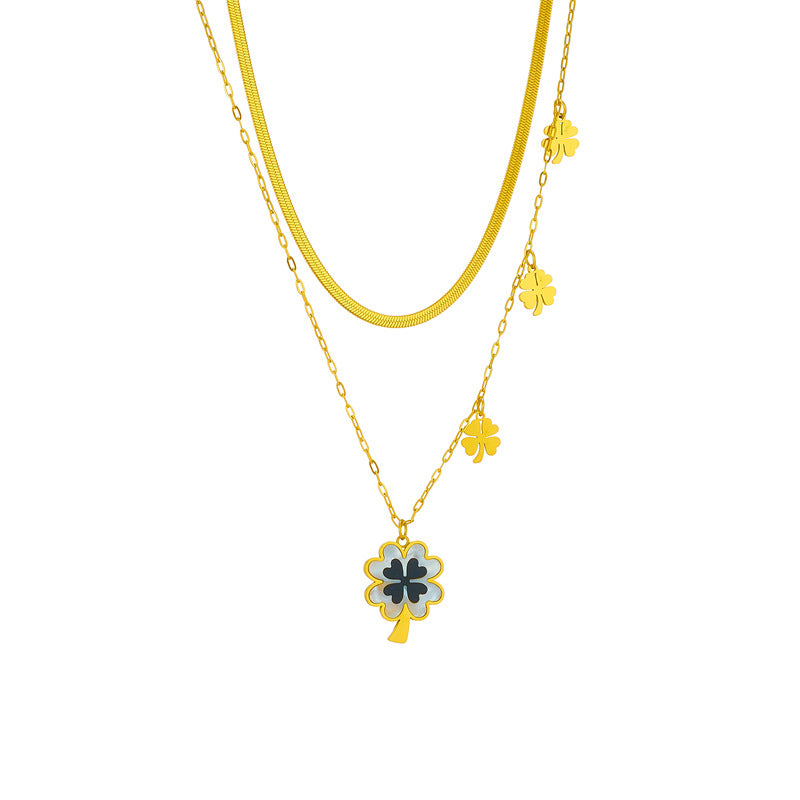 Gold necklace with clover-shaped pendants on a white background