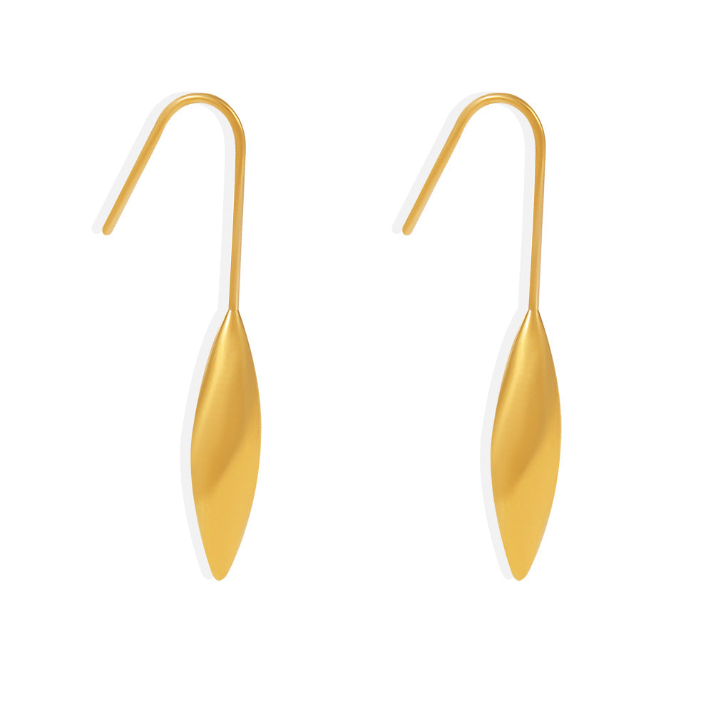 Gold earrings with a leaf-like design on a white background