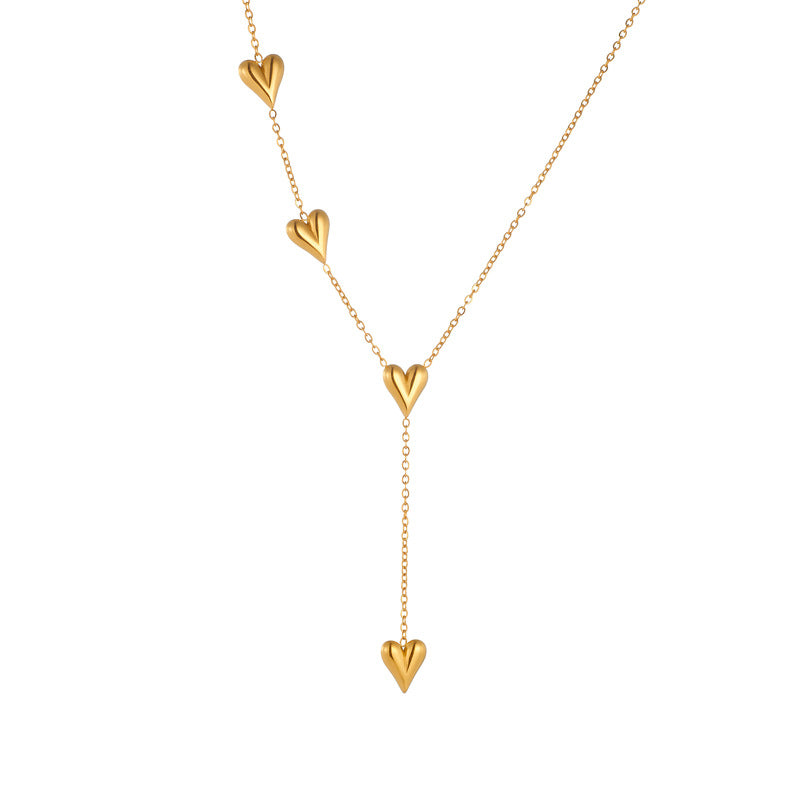 Gold heart-shaped necklace on a white background