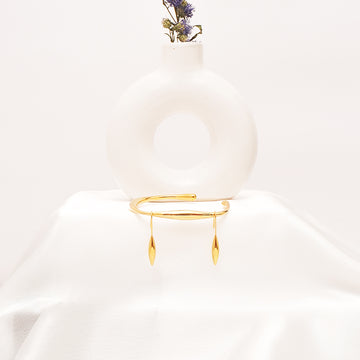 Gold bracelet on a mannequin with a white background