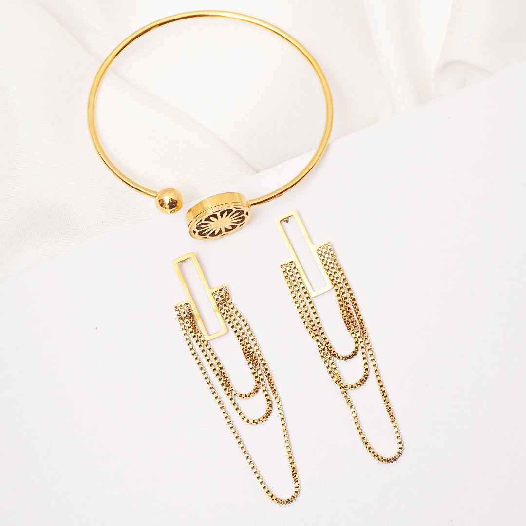 Gold necklace and earrings on a white background