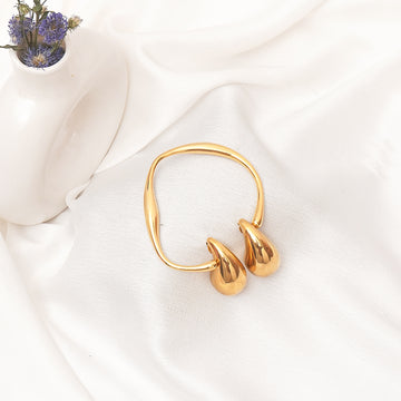 Gold hoop earrings on a white fabric background