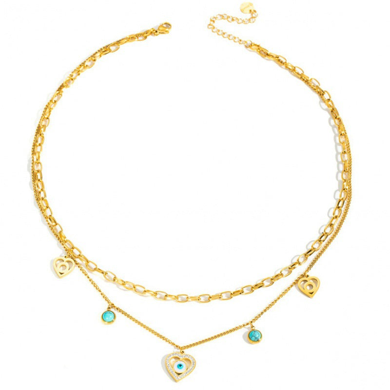 Gold necklace with heart-shaped charms on a white background