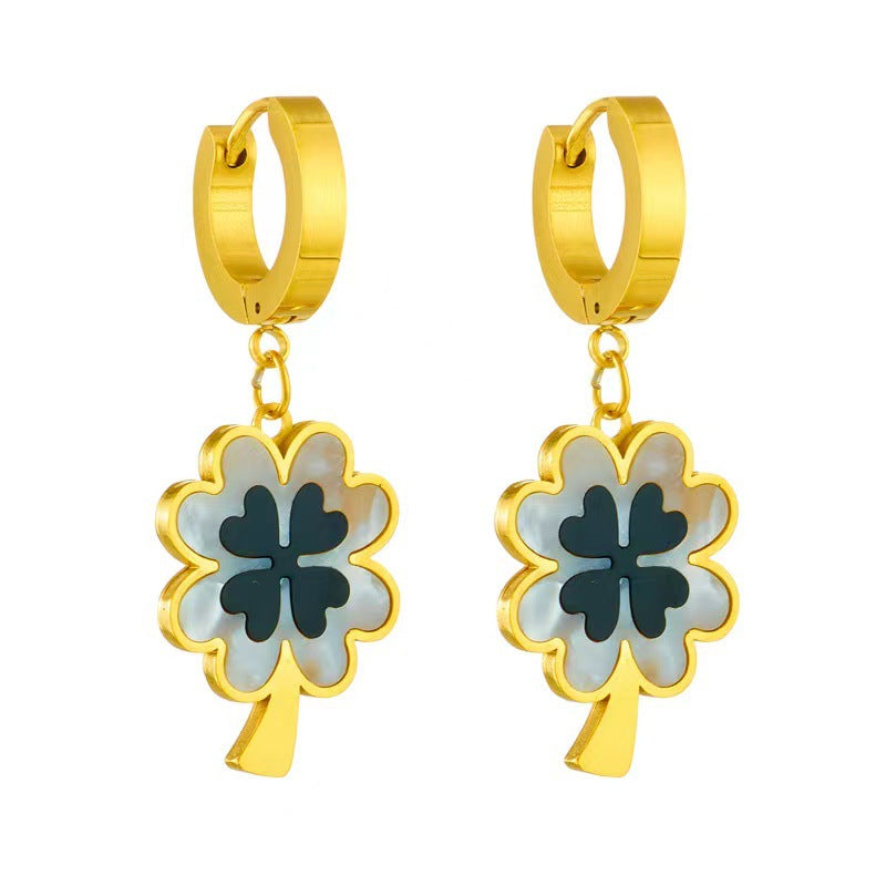 Gold hoop earrings with clover-shaped charms on a white background