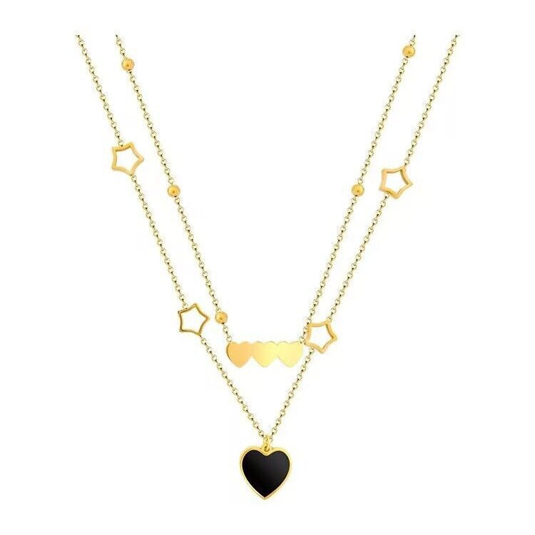 Gold necklace with heart and star pendants on a white background