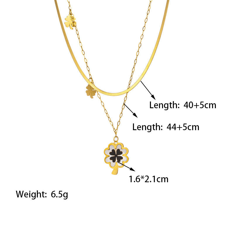 Gold necklace with a clover pendant, showing measurements and weight on a white background.