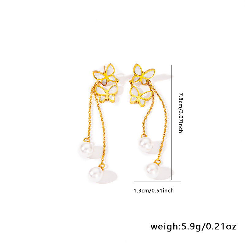 Gold butterfly earrings with pearl drops on a white background, showing measurements and weight.