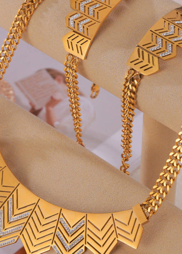 Gold necklace with geometric design on a beige stand