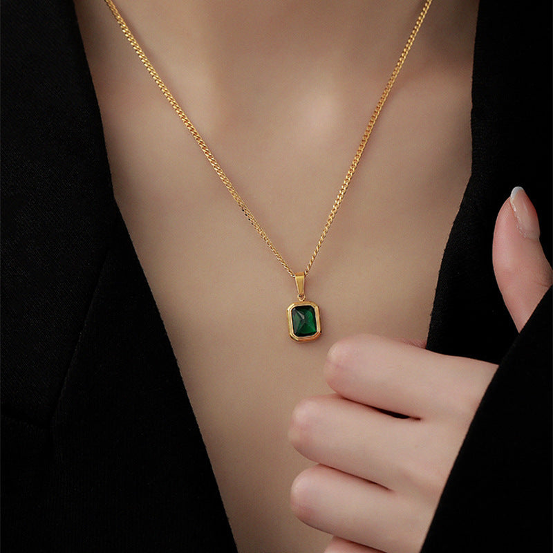 gold bezel emerald cut pendant close up