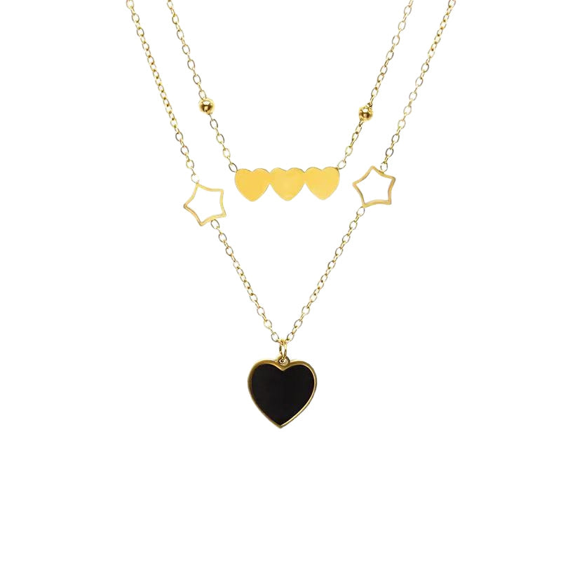 Gold necklace with heart and star pendants on a white background
